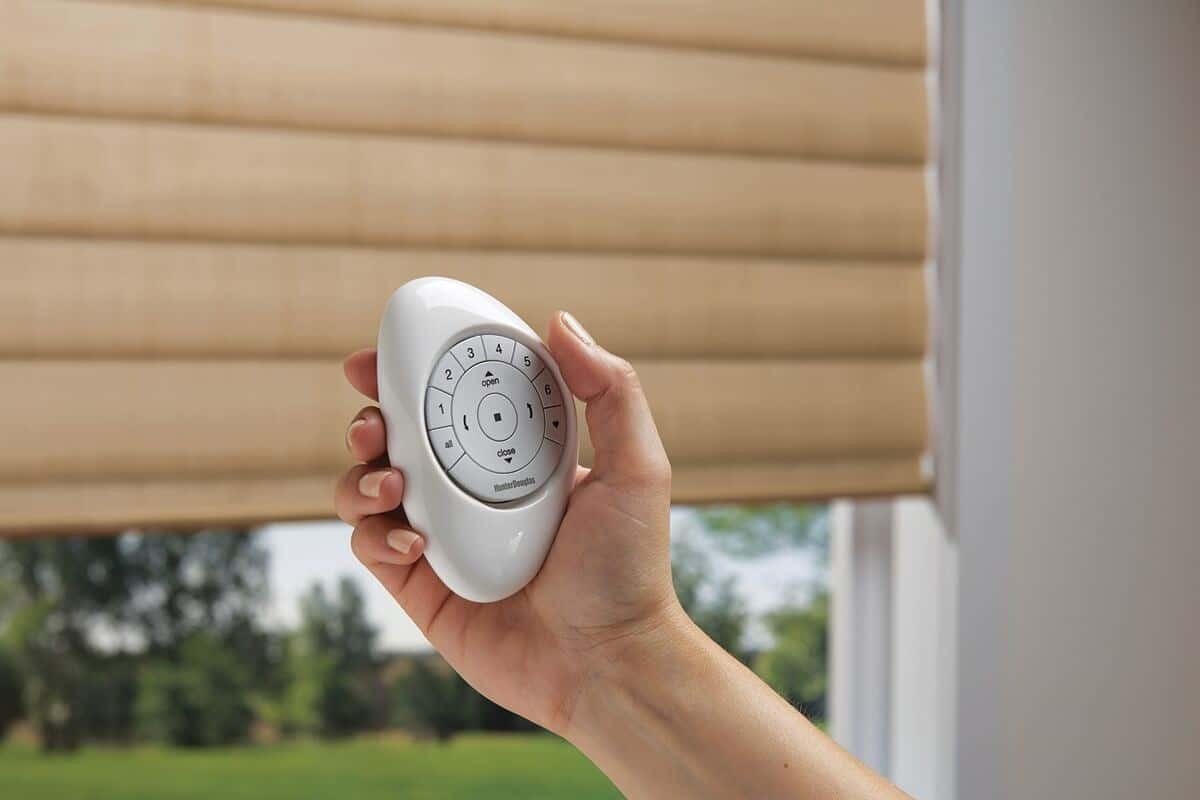 A person using PowerView® Automation Pebble® remote on Hunter Douglas shades near Tacoma, Washington (WA)