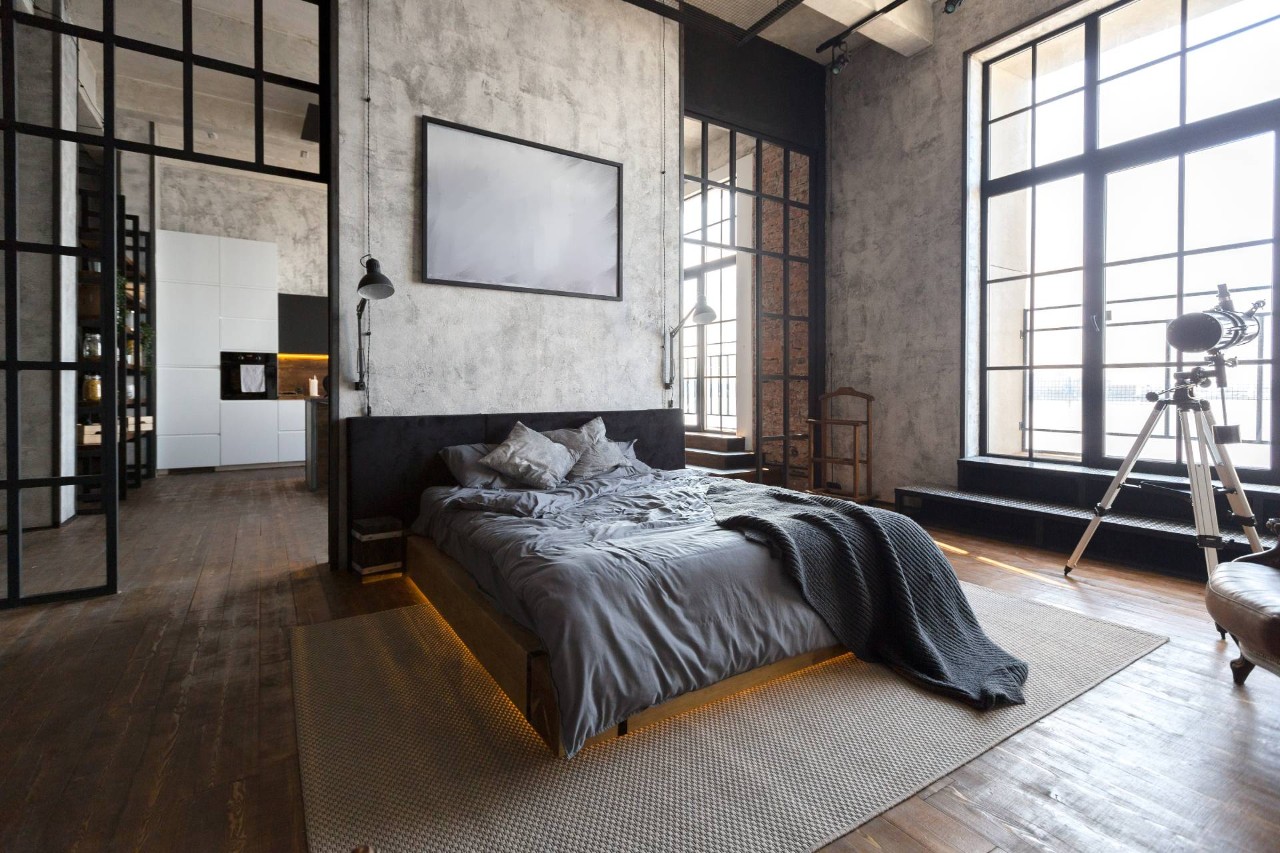 Industrial-style bedroom with large black metal doors and windows at Smart PNW near Tacoma, WA