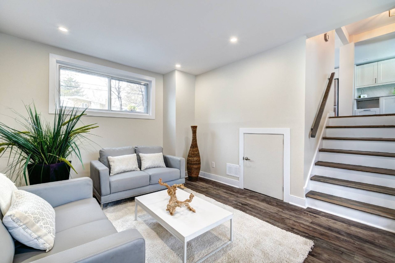  A modern basement with a window featuring no window treatments in a split-level home at Smart PNW near Tacoma, WA