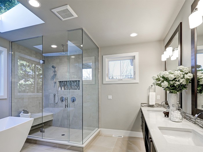 Large bathroom with two vanities and a large glass shower.