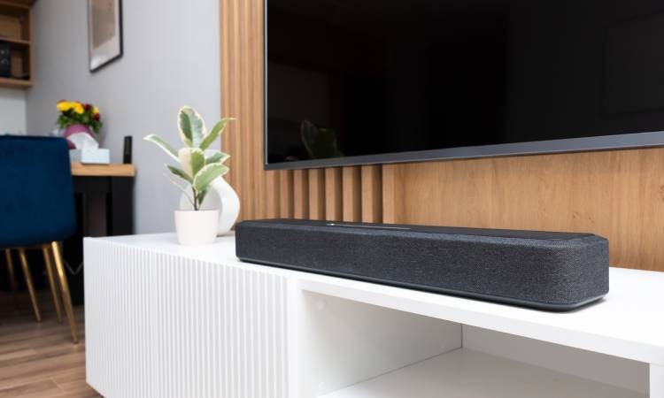 Home audio system’s soundbar on a TV entertainment console in a modern living room at Smart PNW near Tacoma, WA